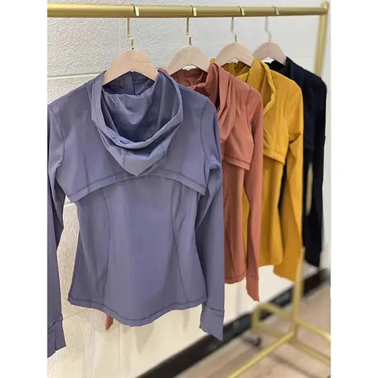 Elite Women's Performance Jacket in various colors on display rack, featuring ergonomic hood and thumb hole design.