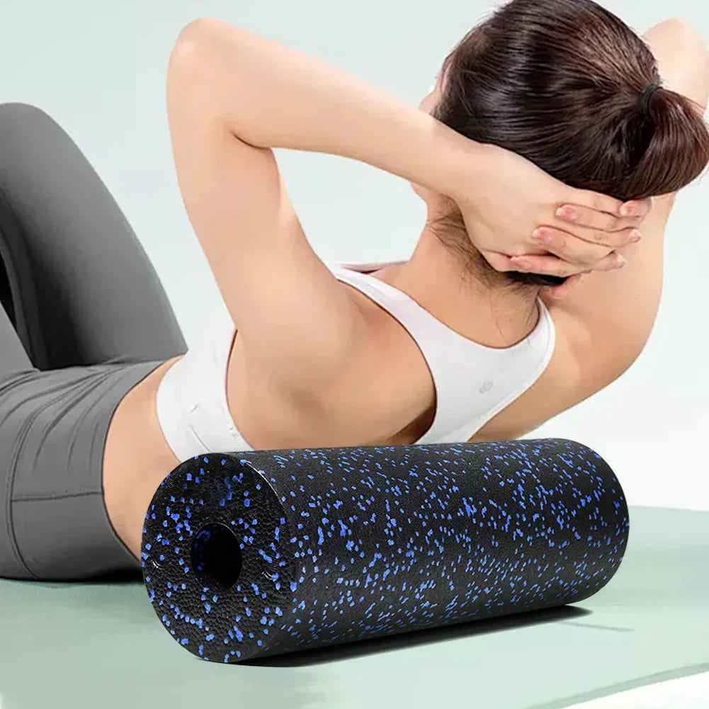EPP Foam Roller for muscle massage and yoga, black with blue speckles, used by a woman for full body massage.