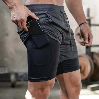 Men's camo 2-in-1 running shorts with quick-dry fabric, shown being worn in a gym setting.