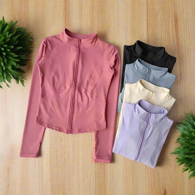 Women's quick-dry long sleeve yoga and fitness top in multiple colors on wooden background.